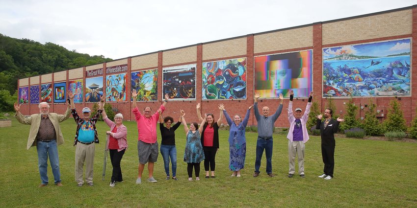 Artists pose in front of Honesdale's Great Wall.